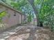 Home backyard with a cemented walkway leading to a door at 829 N Lake Ave, Lakeland, FL 33801