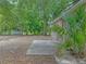Backyard features lush landscaping with concrete patio at 829 N Lake Ave, Lakeland, FL 33801