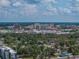 Beautiful aerial view of the neighborhood, green trees, city skyline in the background, and puffy white clouds at 829 N Lake Ave, Lakeland, FL 33801