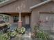 Inviting front porch with brick columns and mature landscaping in front of this home at 829 N Lake Ave, Lakeland, FL 33801