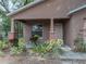 Covered front porch detail of a home with brick columns and freshly landscaped front yard at 829 N Lake Ave, Lakeland, FL 33801