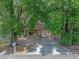 Charming home partially veiled by mature trees, complemented by a well-kept front yard and concrete driveway at 829 N Lake Ave, Lakeland, FL 33801