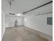 View of a large two-car garage with white walls, concrete floor, new hot water tank and mechanical garage door at 829 N Lake Ave, Lakeland, FL 33801