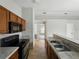 Bright kitchen with wood cabinets, black appliances, and a double stainless steel sink at 829 N Lake Ave, Lakeland, FL 33801