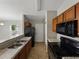 Modern kitchen with wood cabinetry, black appliances and a double stainless steel sink at 829 N Lake Ave, Lakeland, FL 33801