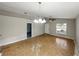 Open-concept living area includes a chandelier, a ceiling fan, and a view of the front door at 829 N Lake Ave, Lakeland, FL 33801