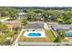 The expansive backyard includes a pool, a patio area, and a white fence that offers peace and privacy at 934 Point View Ln, Lakeland, FL 33813
