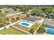 An aerial view of the fenced backyard with a sparkling pool, patio, and well-maintained landscaping at 934 Point View Ln, Lakeland, FL 33813