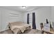 A simple bedroom with a bed, a desk with a chair, and curtains at 934 Point View Ln, Lakeland, FL 33813