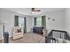 Bright Bedroom with a crib, chair, dresser, and natural lighting from two windows at 934 Point View Ln, Lakeland, FL 33813