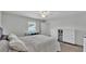 Bedroom featuring a ceiling fan, dresser, and window offering natural light at 934 Point View Ln, Lakeland, FL 33813