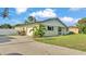 Charming home with a curved driveway, side-entry garage, and lush green lawn at 934 Point View Ln, Lakeland, FL 33813