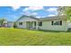 Charming single-story home with a well-manicured lawn, inviting front porch and side-entry garage at 934 Point View Ln, Lakeland, FL 33813