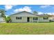 Inviting single-story home featuring a well-maintained lawn and covered front porch seating area at 934 Point View Ln, Lakeland, FL 33813