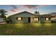 Single-story home at twilight featuring a manicured lawn and inviting front porch seating at 934 Point View Ln, Lakeland, FL 33813