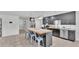 Modern kitchen featuring an island with seating, stainless steel appliances, and stylish dark cabinetry at 934 Point View Ln, Lakeland, FL 33813