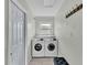 Convenient laundry room with modern washer and dryer units and neutral decor at 934 Point View Ln, Lakeland, FL 33813