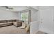 Bright living room with cozy furniture, a ceiling fan, and a large window at 934 Point View Ln, Lakeland, FL 33813