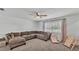 Spacious living room featuring plush carpeting, a large sectional couch, and plenty of natural light at 934 Point View Ln, Lakeland, FL 33813