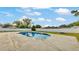 A beautiful kidney-shaped pool surrounded by concrete and a white fence provides privacy in this backyard setting at 934 Point View Ln, Lakeland, FL 33813