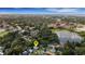 An aerial view of a charming home, set amidst lush trees, with a scenic lake visible in the distance at 941 Avon Ave, Lakeland, FL 33801