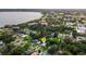 An aerial view of the home nestled in a lush, green neighborhood near a lake at 941 Avon Ave, Lakeland, FL 33801