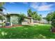 Well-manicured backyard features a lush lawn, mulch beds and a patio area for outdoor enjoyment at 941 Avon Ave, Lakeland, FL 33801