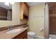 Cozy bathroom featuring vanity with granite countertop, matching wall cabinet and tiled shower with curtain at 941 Avon Ave, Lakeland, FL 33801
