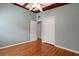 Bedroom with hardwood floors and ceiling fan, featuring access to closets and other areas of the house at 941 Avon Ave, Lakeland, FL 33801