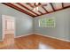 Bedroom with hardwood floors and ceiling fan, featuring access to a walk-in closet and window at 941 Avon Ave, Lakeland, FL 33801