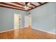 Bedroom with hardwood floors and ceiling fan, featuring access to an en suite bathroom at 941 Avon Ave, Lakeland, FL 33801