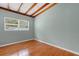 Bedroom with hard wood floors, window and ceiling beams at 941 Avon Ave, Lakeland, FL 33801