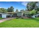 Charming single-story home featuring a well-manicured lawn and covered carport at 941 Avon Ave, Lakeland, FL 33801