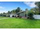 Charming single-story home boasts a well-manicured front lawn and mature landscaping at 941 Avon Ave, Lakeland, FL 33801