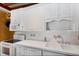 Well-lit kitchen boasting white cabinetry, tile backsplash, and modern appliances at 941 Avon Ave, Lakeland, FL 33801