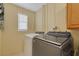 Laundry room features a newer washer and dryer with ample space and lighting at 941 Avon Ave, Lakeland, FL 33801
