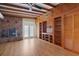Cozy living room featuring hardwood floors, built-in shelves, and a brick fireplace at 941 Avon Ave, Lakeland, FL 33801
