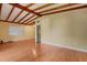Spacious living room featuring hardwood floors and an exposed beam ceiling at 941 Avon Ave, Lakeland, FL 33801