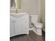 Bathroom showcasing the toilet and cabinet with a white sink at 102 Canterbury Dr, Haines City, FL 33844