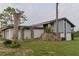 Charming home featuring a stone wall, pillars, manicured lawn, and a two-car garage at 102 Canterbury Dr, Haines City, FL 33844