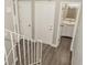 View of hallway from top of stairs, with doors to bathroom and storage closet at 102 Canterbury Dr, Haines City, FL 33844