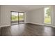 Spacious living room features luxury vinyl plank flooring, sliding door to patio and a picture window at 102 Canterbury Dr, Haines City, FL 33844