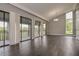 Bright living room with vaulted ceiling, hardwood floors and sliding doors to the balcony at 102 Canterbury Dr, Haines City, FL 33844