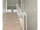 Staircase leading up to the second floor, featuring white railings and carpet at 102 Canterbury Dr, Haines City, FL 33844