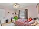 Cozy pink bedroom with large window, eclectic decor, and tiled floors at 1020 E Palmetto St, Lakeland, FL 33801