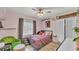 Cozy pink bedroom with large window, eclectic decor, and tiled floors at 1020 E Palmetto St, Lakeland, FL 33801