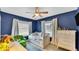 Charming bedroom with daybed, blue accent wall, and a bright window at 1020 E Palmetto St, Lakeland, FL 33801