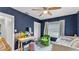 Stylish bedroom featuring blue walls, a green chair, and a makeup vanity at 1020 E Palmetto St, Lakeland, FL 33801