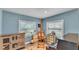 Bright living room showcasing an art easel, piano, and wood-look flooring at 1020 E Palmetto St, Lakeland, FL 33801