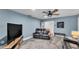 Inviting living room with a comfortable sofa, entertainment center, and ceiling fan at 1020 E Palmetto St, Lakeland, FL 33801